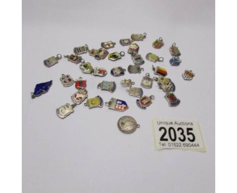 36 silver and enamel charms principally of town and city crests and a 1901 3d bit (approximately 49 grams in total).