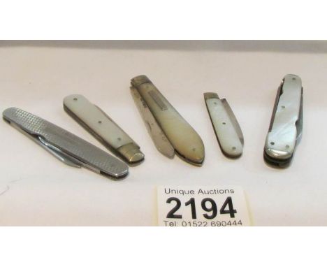 4 silver and mother of pearl pen knives and one other.