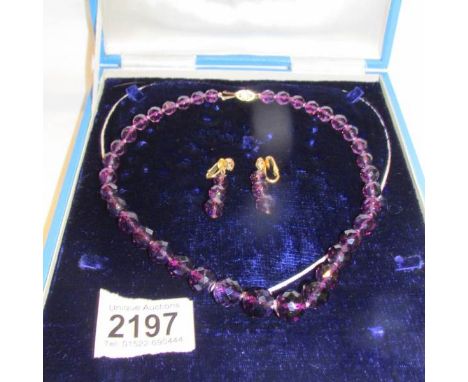A cased 14ct gold and amethyst necklace and earrings.