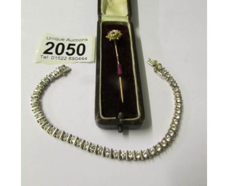 A Victorian stick pin set ruby and seed pearls together with a silver bracelet set cubic zirconia's.