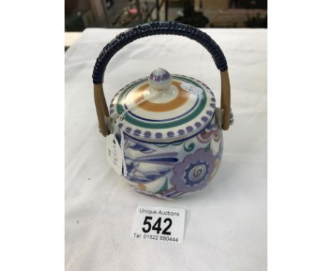 A Poole pottery honey pot with wicker handle