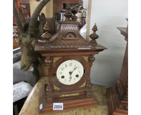 An oak cased mantel clock (missing glass).