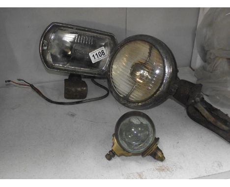 A 1940's Vauxhall spot light, a Lucas square 8 and a brass bullseye side light