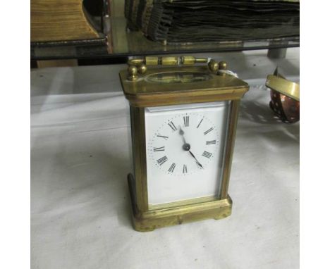 A brass carriage clock.