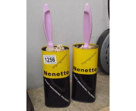 A pair of vintage Nenette dust absorbing polisher tins