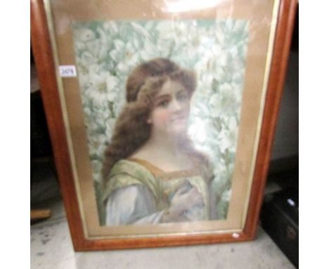 A Victorian portrait of a lady in a birds eye maple frame.