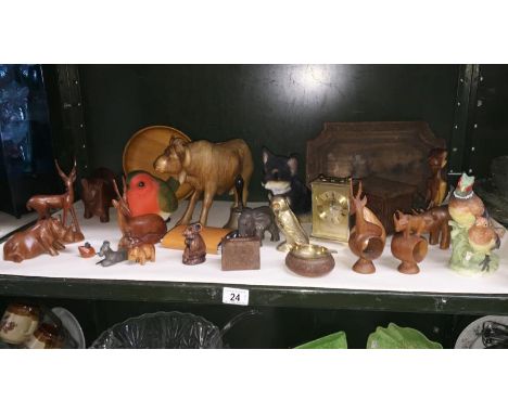 A shelf of wooden animals etc.