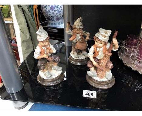 3 period folk costumed boy figurines each playing pretend instruments
