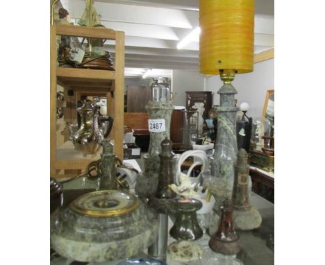 A collection of Cornish Serpentine including lighthouse lamp, lighthouse cigarette lighter, other lighthouses, barometer etc.