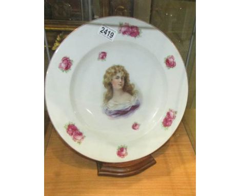 A large cabinet plate with portrait of a lady.