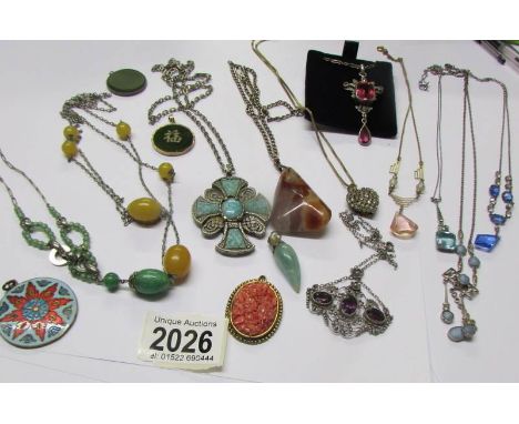 A mixed lot of vintage pendants and necklaces etc.,