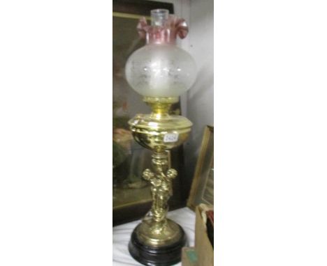 A good quality oil lamp with figural column and etched shade.