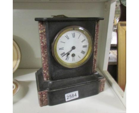 A Victorian black slate mantel clock.
