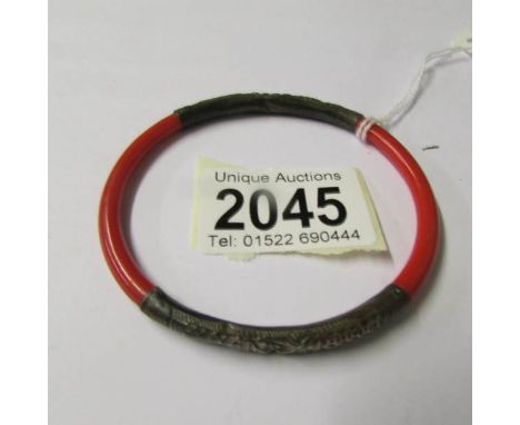 A silver and coral bangle.