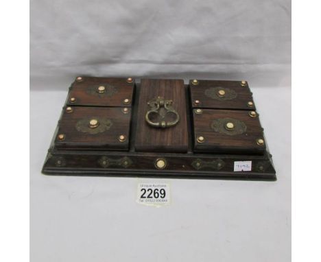 A Chinese oak box containing 19th century mother of pearl and bone counters.