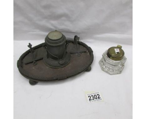 An old inkstand with compass in lid and a glass inkwell.