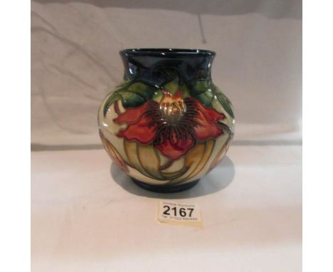 A Moorcroft Anna Lilly pattern jardiniere vase, approximately 5.75" tall.