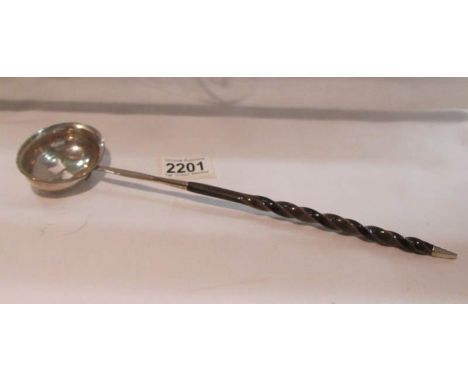 A white metal ladle with barley twist handle (possibly Georgian).