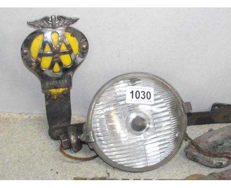 A Lucas spot light and an AA car badge