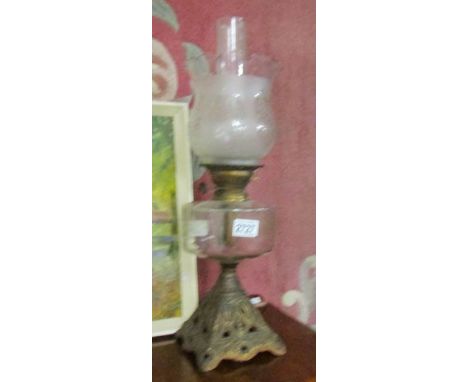 A Victorian oil lamp on metal base with glass font and later glass shade.