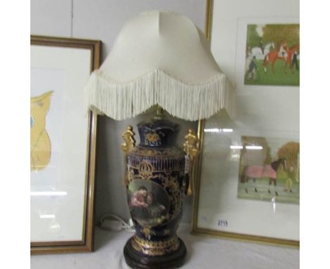 A pottery table lamp with shade.