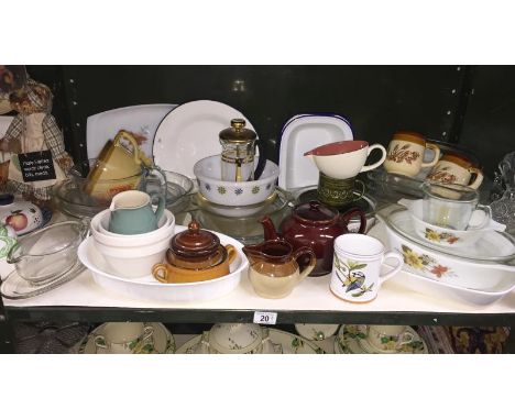 A shelf of kitchenware, mostly Pyrex