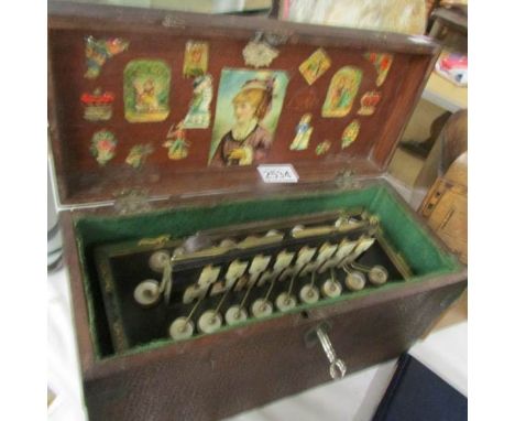 A 19th century Busson Flutina accordion with mother of pearl keys and floral decorated bellows in box.
