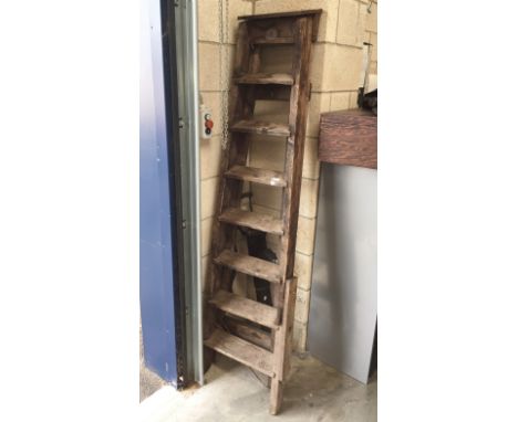 A tall wooden step ladder