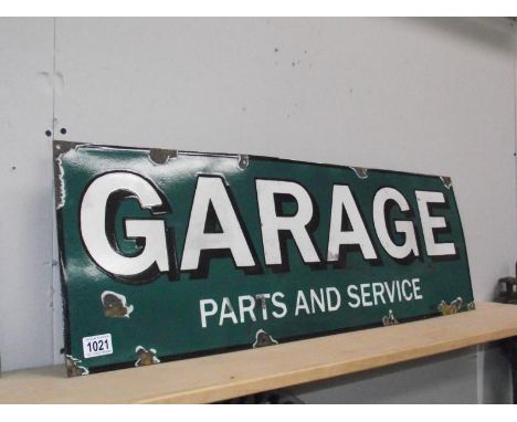 An enamel sign 'Garage Parts and Service'