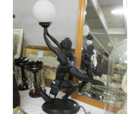 A modern figural table lamp with shade.