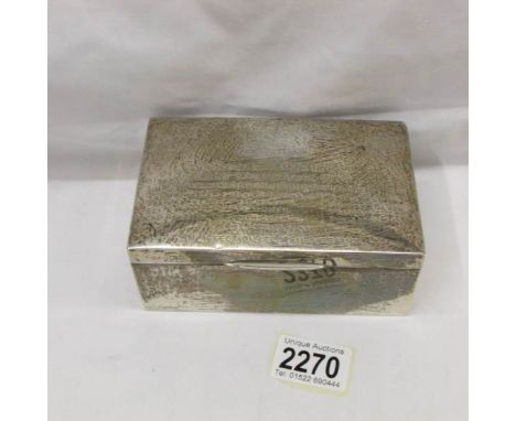 A silver trinket/cigarette box hall marked Birmingham 1915 featuring an engraving of the Manchester Regiment crest and dedica