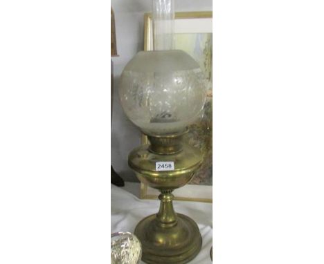 A Victorian brass oil lamp with original shade.