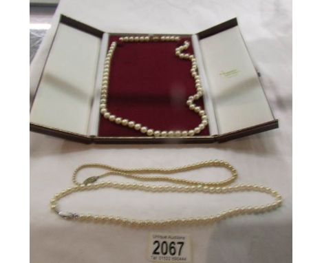 A pearl necklace with gold clasp and 2 other pearl necklaces.