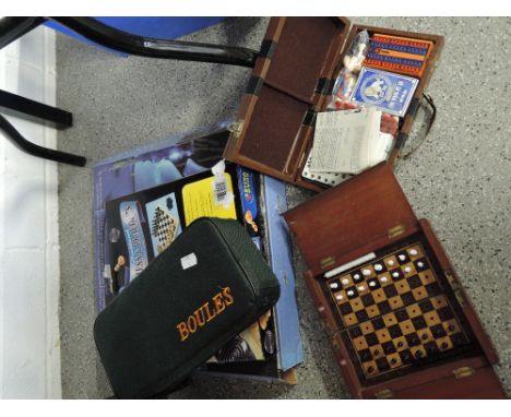 A selection of vintage board and travel games including folding wooden chess set