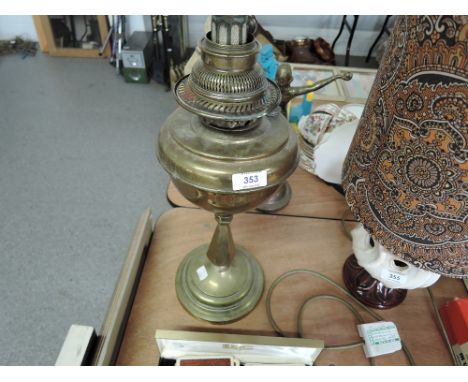 A vintage brass bodied oil burning lamp