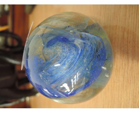 A piece of art glass in the form of a unicorn horn and a glass paperweight 