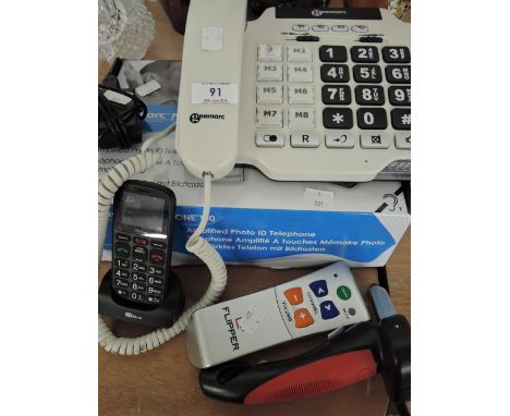 A selection of Aids to the elderly, large numeral and loud speaker telephone mobile phone, TV remote etc