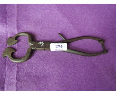 An unusual cast iron tool possibly a medical instrument or farming item