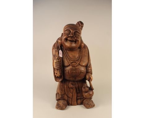 A large vintage carved wood Buddha figure with gourd on rope in hand and a tied sack on his back, 63cm tall 