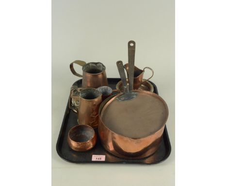 A 19th Century seamed copper saucepan and lid plus a quantity of small copper items to include jugs, wine coaster etc