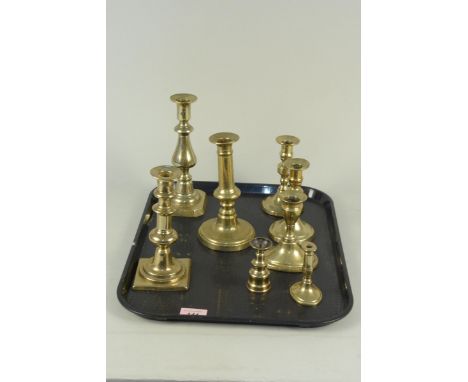 An early 19th Century brass taperstick, miniature brass pricket candlestick, a pair of small early 19th Century brass candles
