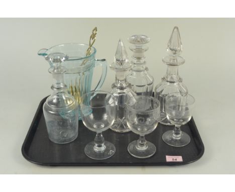 A mixed lot of glass comprising of four various 19th Century decanters, three wine glasses, a blue jug and two brass spoons