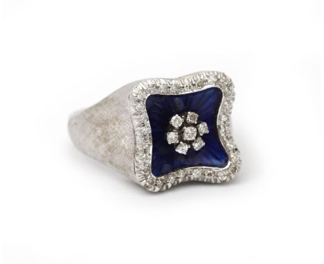 An 18 karat white gold diamond and enamel ring. Featuring a square panel with a diamond cluster in the center, embellished wi