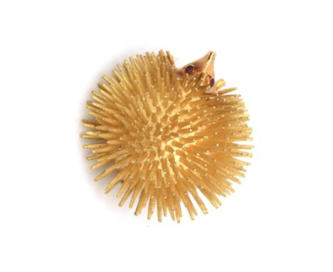 An 18 karat gold ruby hedgehog brooch, ca. 1970-'80. Spines and head are satinated. Eyes are set with rubies. French maker's 