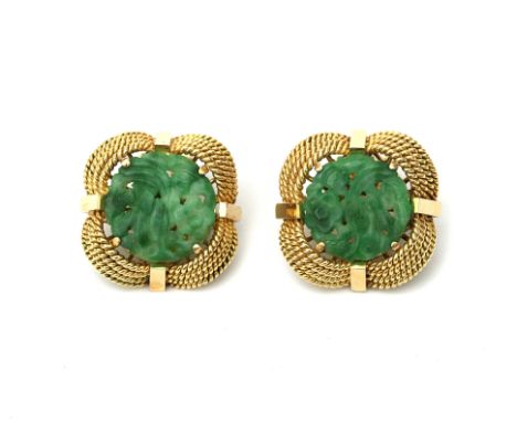 A pair of 14 karat gold jadeite ear clips. Featuring floral carved jade- jadeite, set in an ornate gold rope work mount. Gros