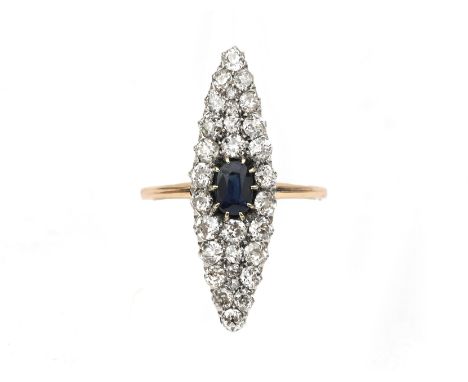 A 14 karat gold diamond and sapphire navette ring. Featuring a cushion cut sapphire of ca. 0.75 ct. in a diamond surround of 