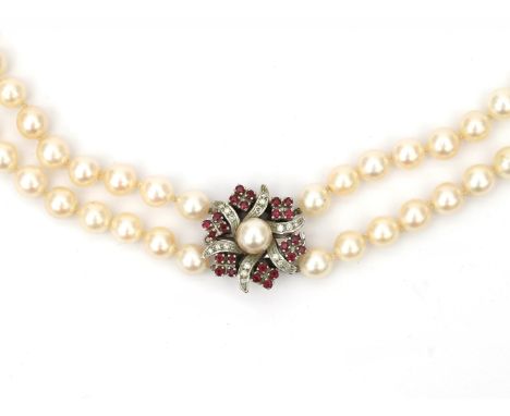 A cultured pearl necklace to a ruby and diamond white gold clasp. Featuring two knotted strands of saltwater cultured pearls.