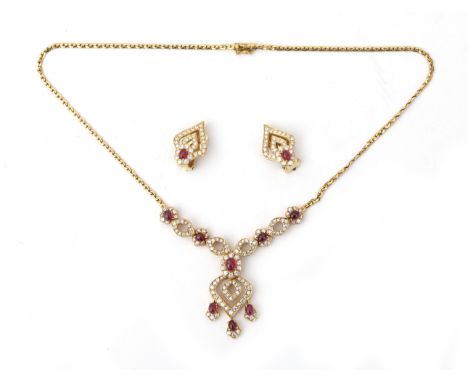 An 18 karat gold ruby and diamond necklace with matching earrings. Earrings in 14 karat gold and of later date. Provenance: F