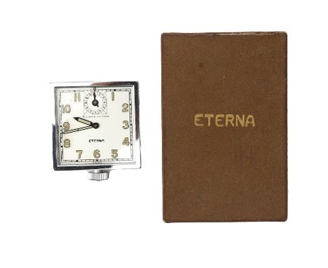 A steel Eterna automobile clock, ca. 1950. 8 days alarm, Incl. shop tags and box. 