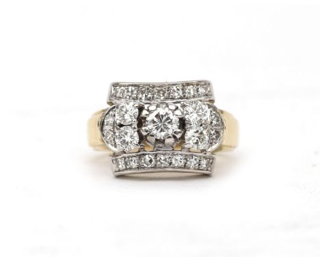 A 14 karat gold cocktail ring, ca. 1950. Featuring a  cluster of five larger diamonds of ca. 0.75 ct. in total, ca. G-H, ca. 
